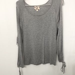 Gray sweater with slits down arms with ties